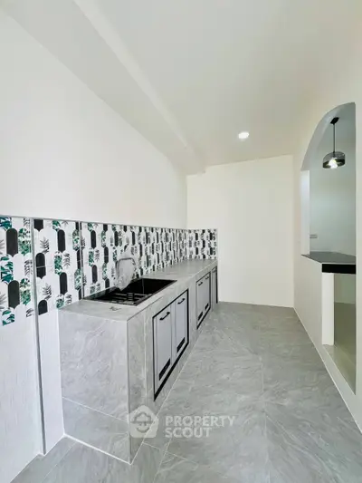 Modern kitchen with sleek design and stylish tile backsplash