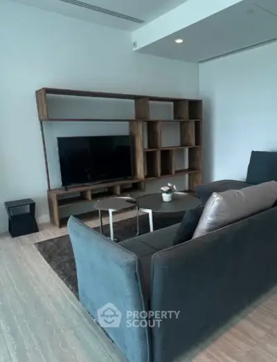 Modern living room with sleek furniture and stylish shelving unit