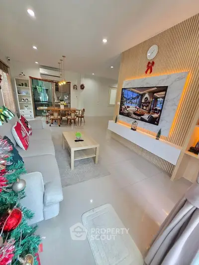 Spacious living room with modern decor and festive holiday touches