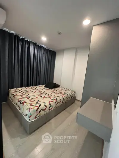 Modern bedroom with stylish decor and ample natural light