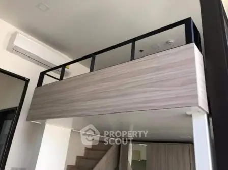 Modern loft-style interior with sleek wooden finishes and air conditioning unit.