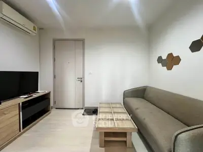 Modern living room with sleek furniture and minimalist decor, featuring a comfortable sofa and entertainment unit.