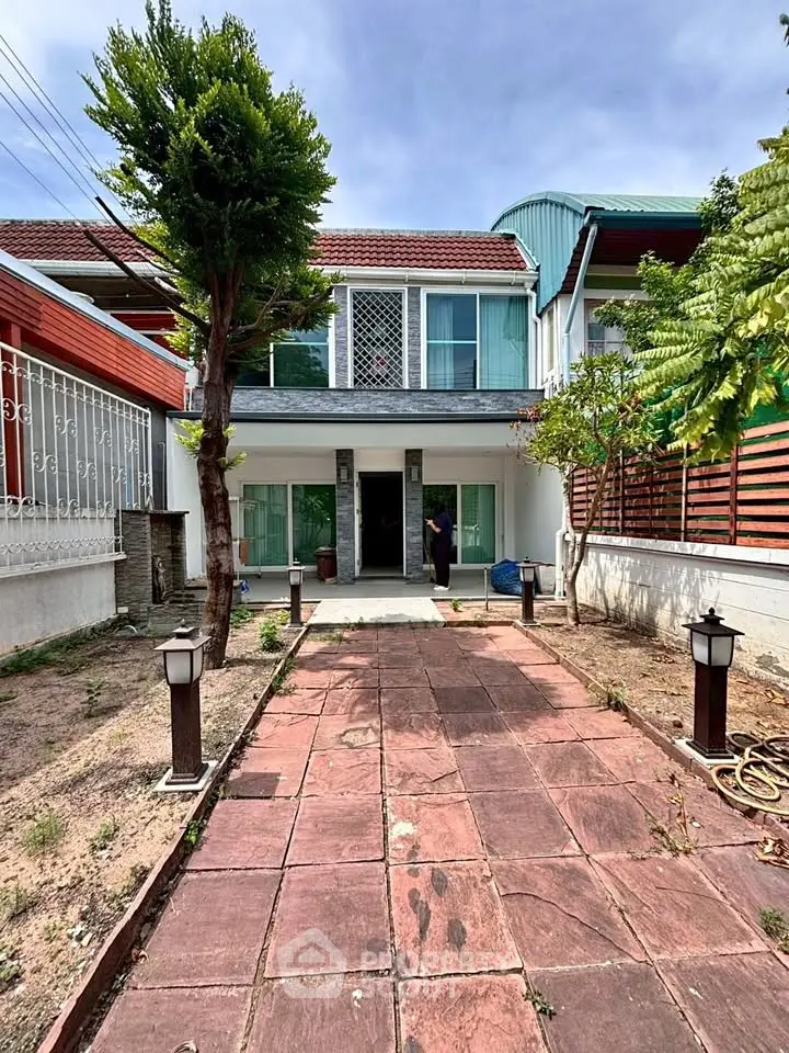 Charming two-story house with spacious front yard and modern exterior design.