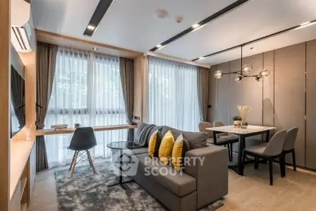 Modern living room with stylish decor and large windows in a contemporary apartment.
