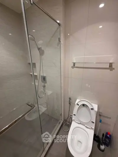 Modern bathroom with glass shower and sleek toilet design