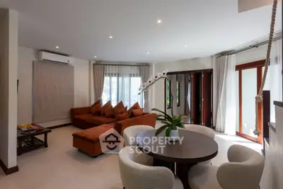 Spacious living room with modern furniture and large windows offering natural light.