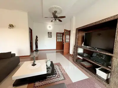 Spacious living room with elegant decor and entertainment center