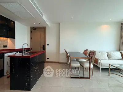 Modern open-plan living room with sleek kitchen and elegant dining area