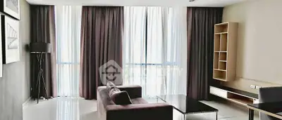 Modern living room with floor-to-ceiling windows and elegant curtains