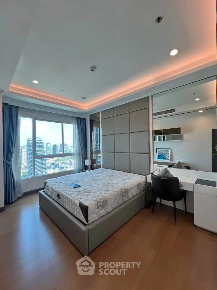 Luxurious bedroom with city view, modern furnishings, and elegant lighting.