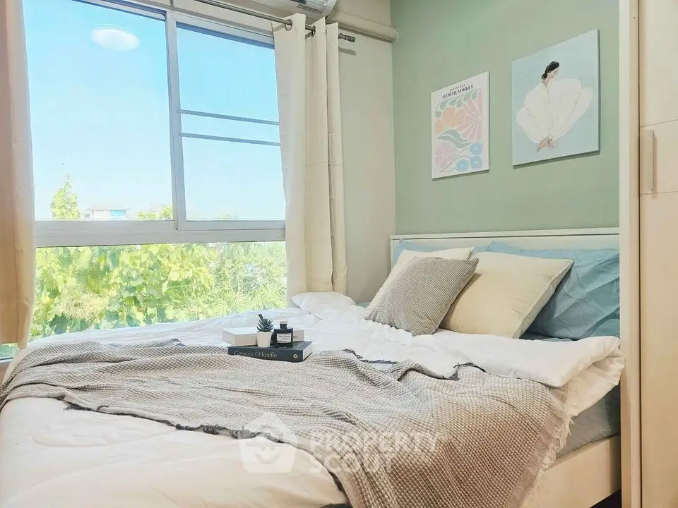 Cozy bedroom with large window and stylish decor, offering a serene and inviting atmosphere.
