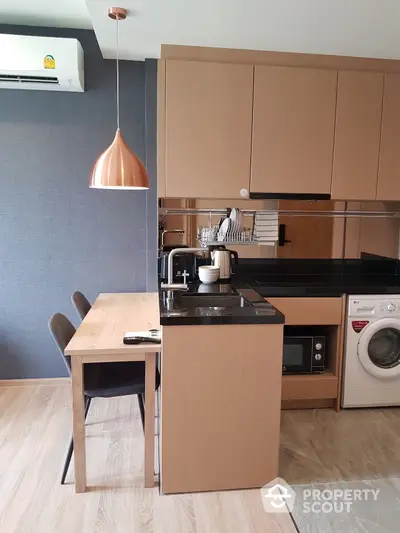 Modern kitchen with sleek design, featuring wooden cabinetry and integrated appliances.