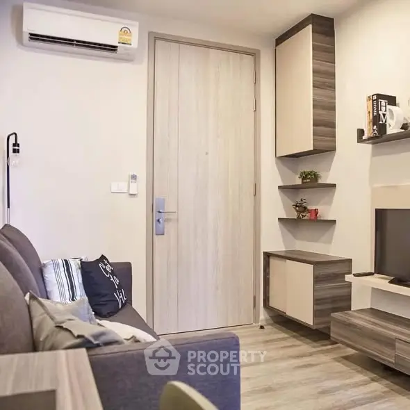 Modern living room with sleek furniture and air conditioning in a cozy apartment.