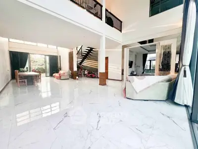 Spacious modern living room with high ceilings and elegant marble flooring