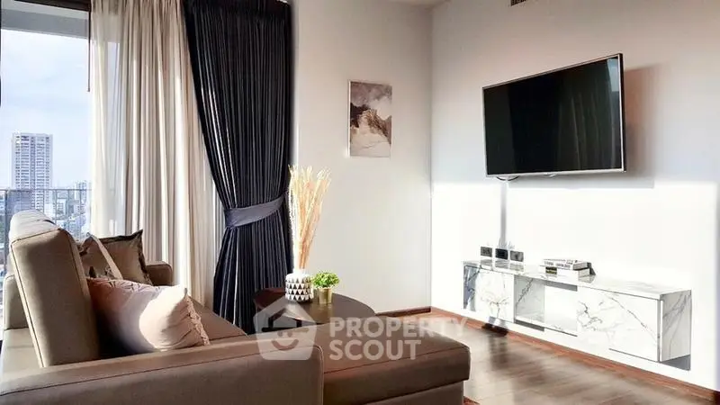 Modern living room with sleek TV setup and city view, featuring elegant decor and natural light.