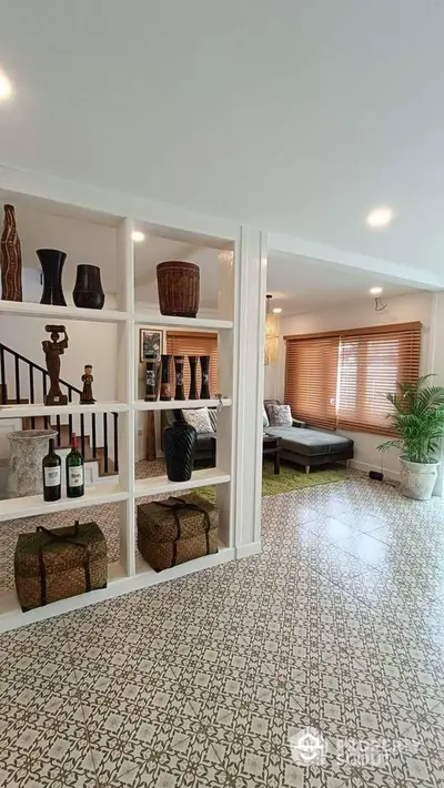 Stylish living room with decorative shelving and patterned tile flooring