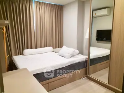 Modern bedroom with mirrored wardrobe and cozy bed in stylish apartment