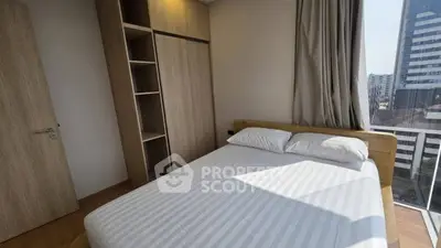 Modern bedroom with city view, featuring built-in wardrobe and cozy bed.
