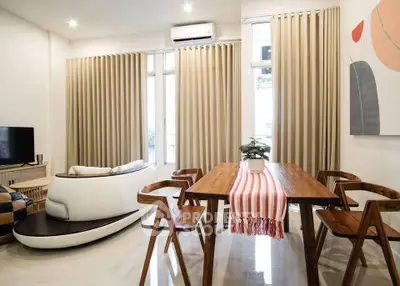 Modern living room with stylish furniture and natural light, perfect for relaxation and entertainment.
