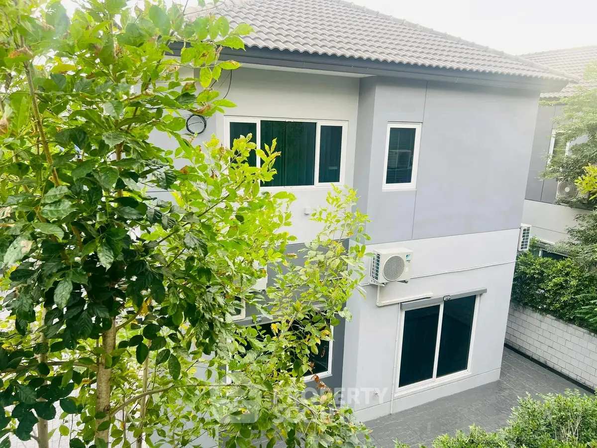 Modern two-story house with lush greenery and sleek exterior design