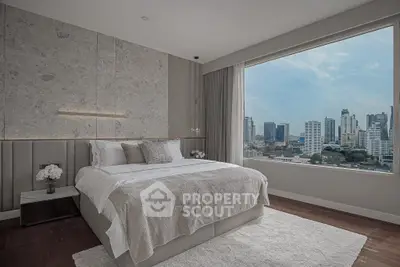 Luxurious bedroom with stunning city view and elegant decor in modern apartment.