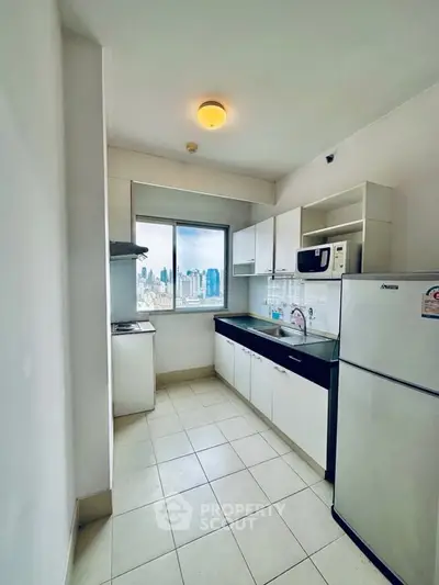 Modern kitchen with city view, featuring sleek appliances and ample storage space.