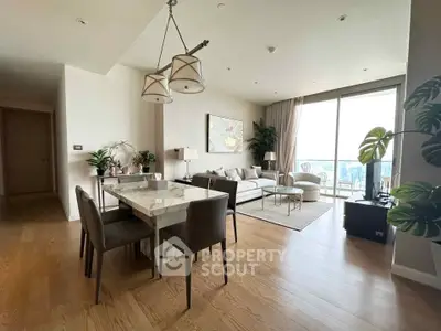 Spacious modern living room with dining area and large windows offering stunning views.
