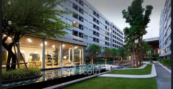 Modern apartment complex with pool and lush landscaping