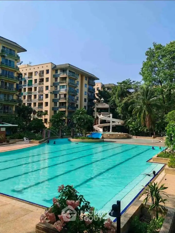 Luxurious residential complex with a stunning outdoor pool and lush greenery, perfect for relaxation and leisure.