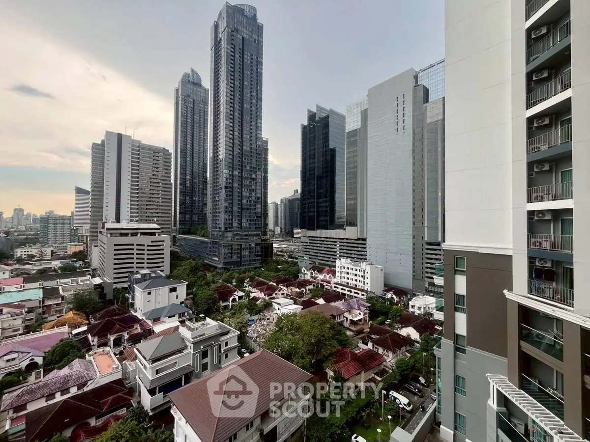 Stunning cityscape view from high-rise apartment overlooking urban skyline and residential area.