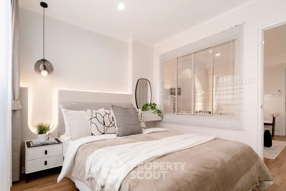 Cozy modern bedroom with stylish decor and natural light