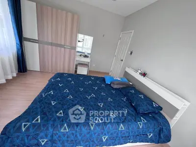 Spacious bedroom with modern decor and ample natural light
