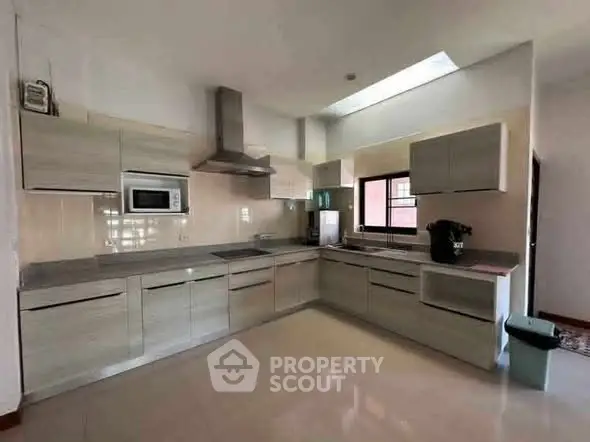 Modern kitchen with sleek cabinets and stainless steel appliances in a spacious layout.
