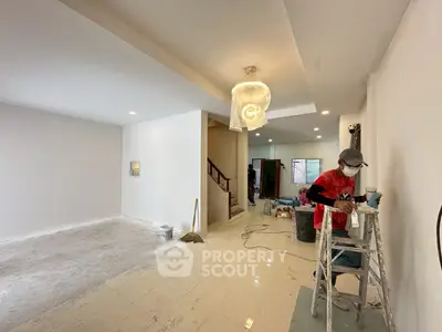 Spacious interior under renovation with modern lighting and open layout, ideal for customization.