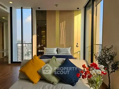 Luxurious bedroom with floor-to-ceiling windows and vibrant decor in a high-rise apartment.