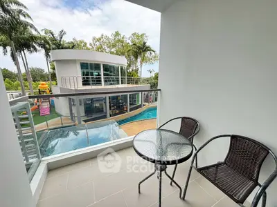 Modern balcony with pool view and stylish outdoor seating