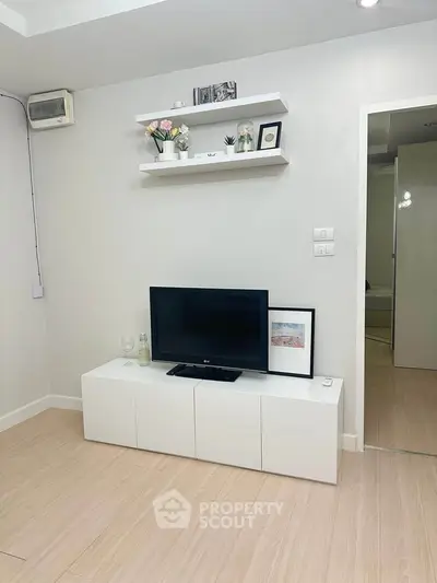 Modern living room with minimalist decor and sleek white furniture