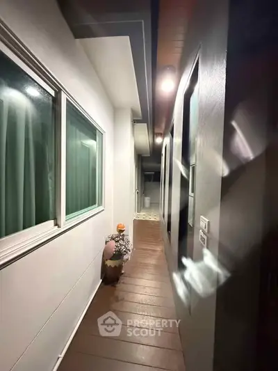 Modern corridor with sleek design and ambient lighting in a contemporary home.