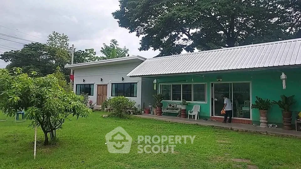 Charming single-story home with lush green garden and modern exterior design.