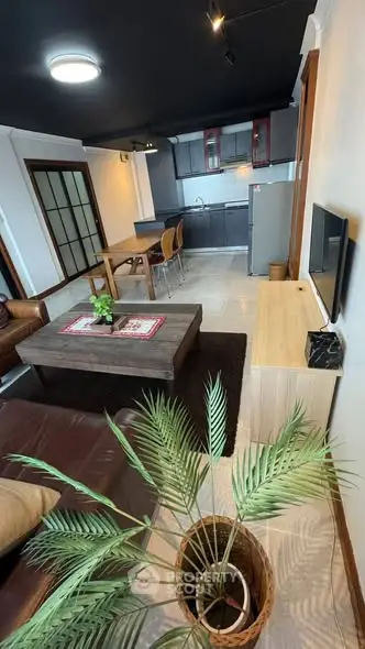 Modern open-layout living room with stylish kitchen and cozy seating area