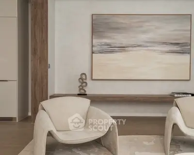 Modern living room with stylish chairs and abstract art on the wall.