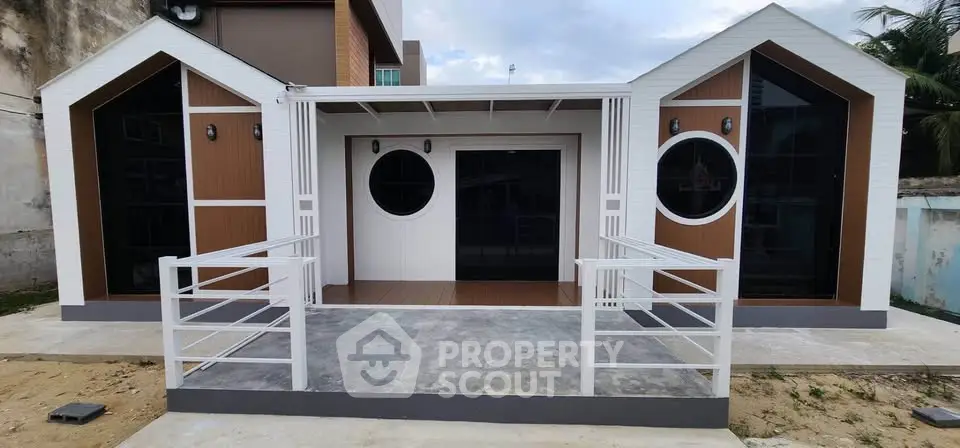 Charming modern exterior with unique circular windows and sleek design.