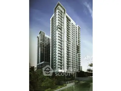 Stunning modern high-rise building with sleek architecture and lush surroundings, perfect for urban living.