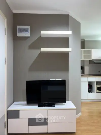 Modern living room with sleek TV stand and open kitchen layout