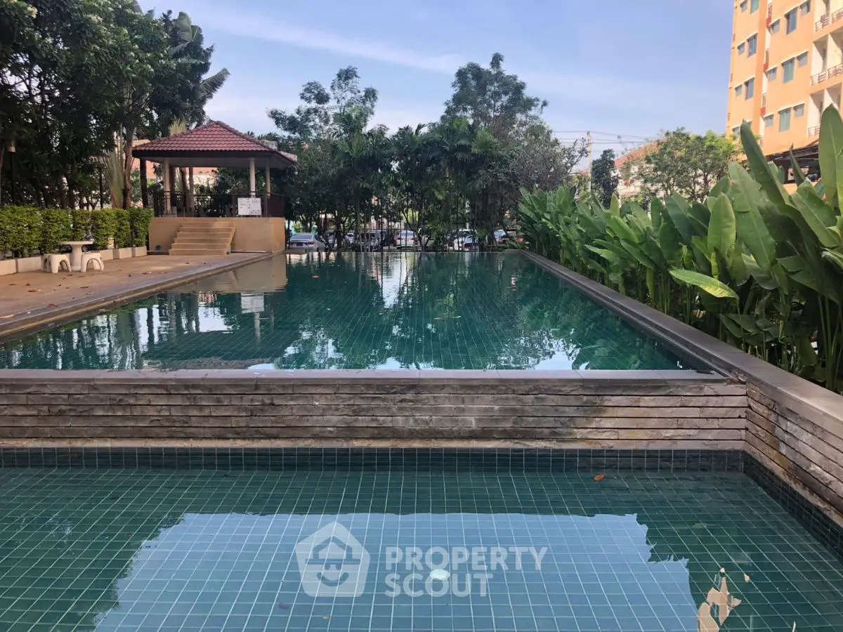 Stunning pool area with lush greenery in a modern residential complex.