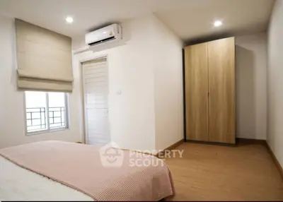 Cozy bedroom with modern air conditioning and ample natural light