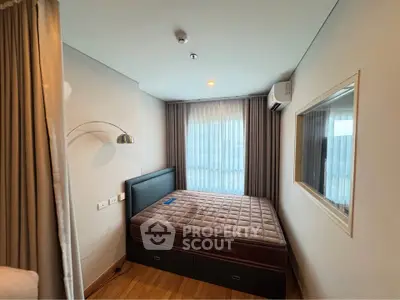 Cozy bedroom with modern decor and natural light, featuring a comfortable bed and stylish lighting.