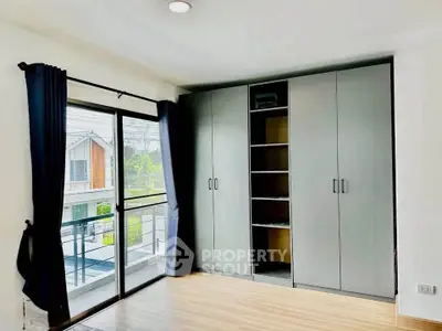 Bright bedroom with large wardrobe and balcony access in modern home