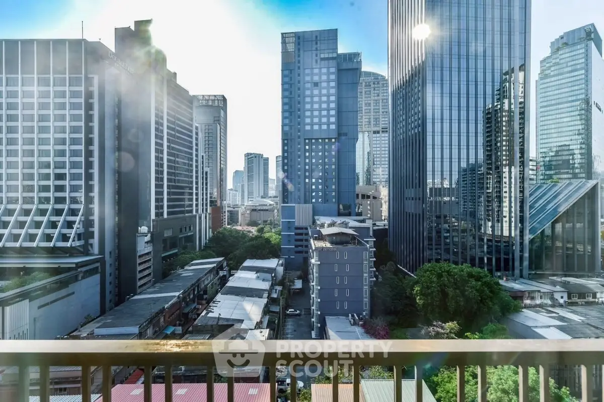 Stunning cityscape view from a high-rise balcony in a bustling urban area.