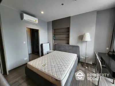 Modern bedroom with sleek design and air conditioning in a stylish apartment.